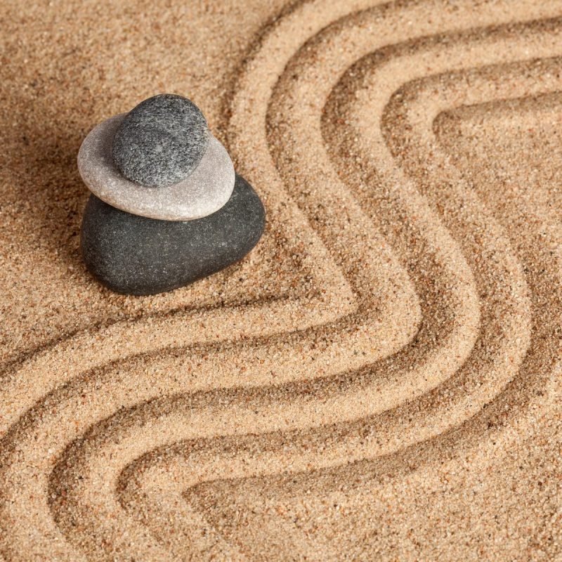 Japanese Zen stone garden - relaxation, meditation, simplicity and balance concept - pebbles and raked sand tranquil calm scene