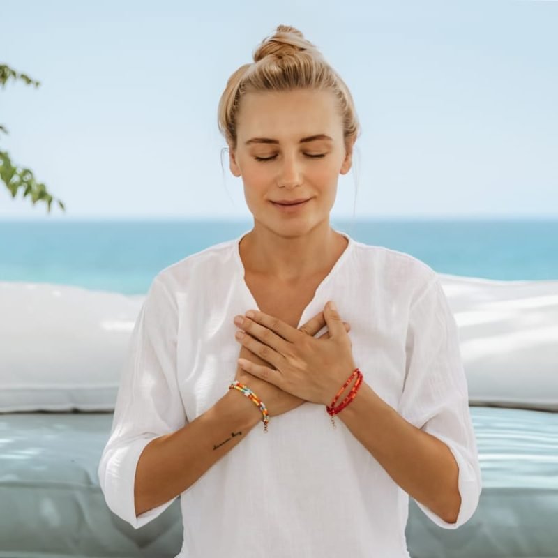 60671044_calm-female-doing-yoga-near-the-sea